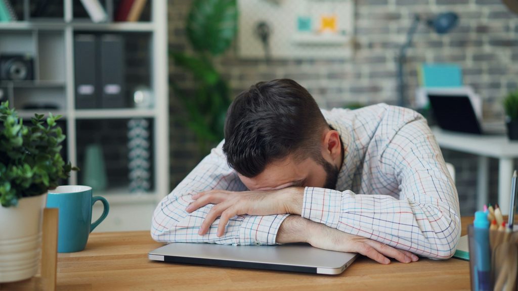 Business professional feeling overwhelmed by social media content creation.