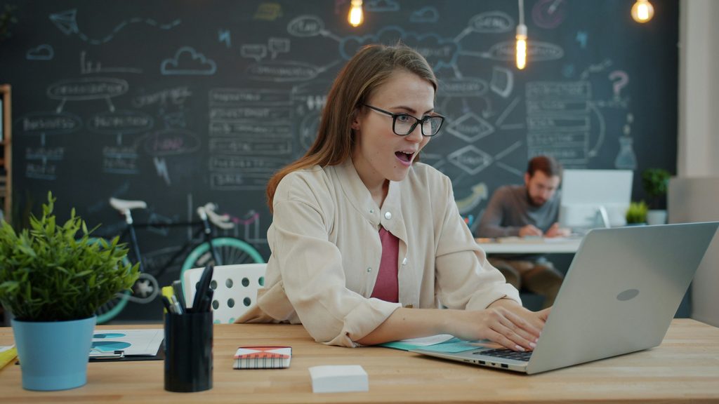 Entrepreneur reviewing email automation results on a laptop dashboard